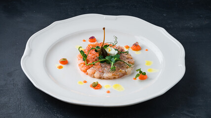 Snack salmon and sea bream tartare with microgreens and capers.