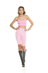a young woman in pink short leggings and top, and black leather boots walking on a white background