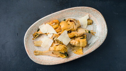 Pieces artichokes with parmesan cheese and herbs.