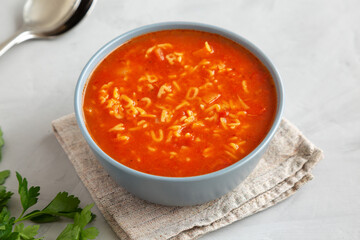Homemade Alphabet Soup in Tomato Sauce in a Bowl, side view. Close-up.