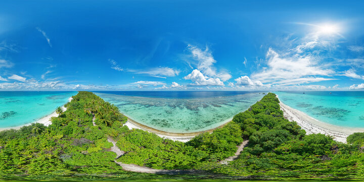 Panoramic view of one of the atolls in the Maldives from a bird's eye view. A thin strip of land of sand connecting the larger parts of the island. Aerial seamless 360 degree spherical panorama