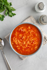 Homemade Alphabet Soup in Tomato Sauce in a Bowl, top view. Overhead, from above, flat lay.