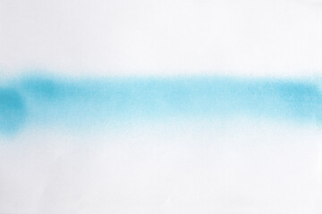 blue line of spray paint on white paper