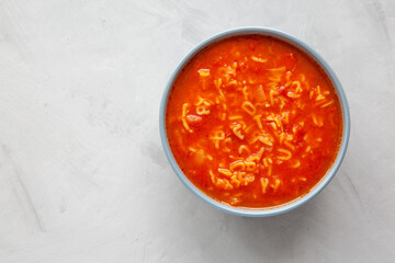 Homemade Alphabet Soup in Tomato Sauce in a Bowl, top view. Overhead, from above, flat lay.