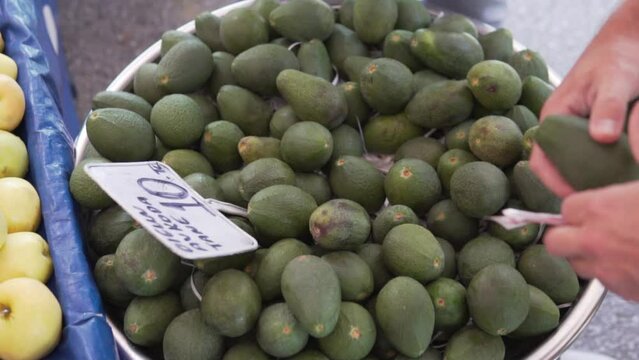 A man buys an avakado at a farmer's market in Turkey