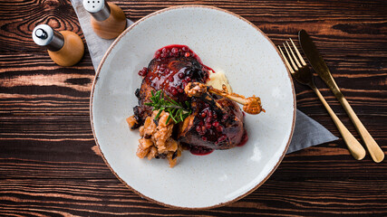 Roast duck with cranberry sauce, mashed potatoes and baked apple slices.