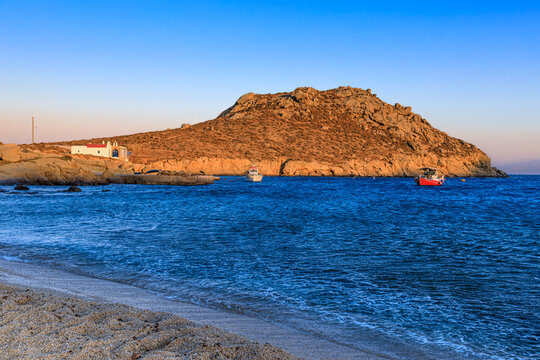 Greece summertime: Paralia Agia Anna Beach in island of Mykonos. Paralia Agia Anna Beach is a small sandy beach near Kalafatis , by a fishing port.  