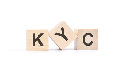 KYC - wooden blocks with letters, top view on white background