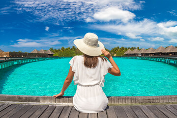 Woman sitting on the wooden pier