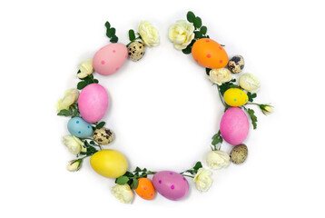 Easter decoration. Circle Easter frame of colored easter eggs and white roses flowers on white background with space for text. Top view, flat lay