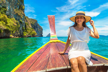 Woman relaxing on boat - obrazy, fototapety, plakaty