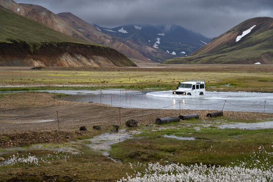 4WD car crossing a river near Landmannalaugar campsite in Icelanding highlands