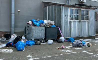 Overflowing garbage cans and rubbish lying around. The wind blows rubbish and trash bags. The...