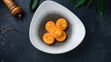 Fried crispy rice snacks in bowl.