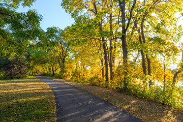 Beautiful park walking path along the Mississippi River in colorful fall autumn foliage