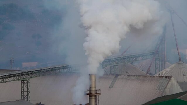 Factory expelling pollution and smoke through a chimney. Environmental problem