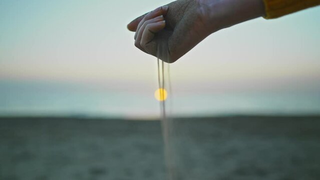 Sand slips through your fingers. Time is fleeting.