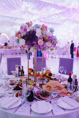 decoration of the served table with a bouquet on a stand