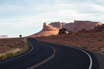 empty curvy road in Glen Canyon with balanced rock landscape, Arizona