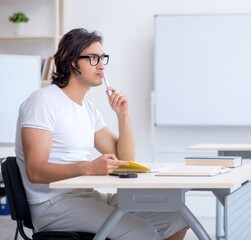 Young male student in front of whiteboard