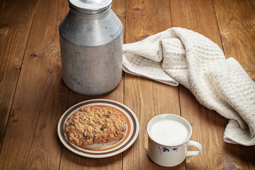homemade cookies and cup of milk on wooden table