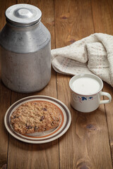 homemade cookies and cup of milk on wooden table