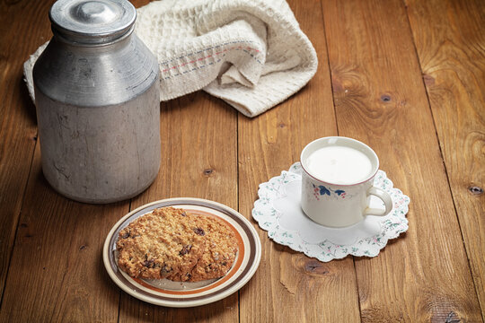 homemade cookies and cup of milk on wooden table