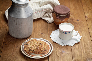 homemade cookies and cup of milk on wooden table