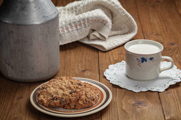 homemade cookies and cup of milk on wooden table