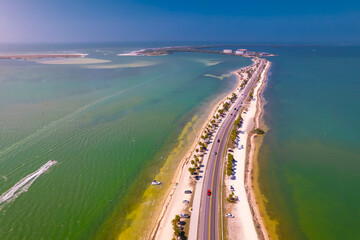Florida beach. Panorama of Honeymoon Island State Park. Spring or Summer vacations in USA. Dunedin FL Causeway. Blue-turquoise color of salt water. Ocean or Gulf of Mexico. Aerial view. Seascape photo