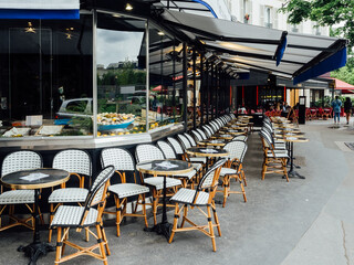 Cozy street with tables of cafe in Paris, France. Architecture and landmark of Paris. Cozy Paris cityscape