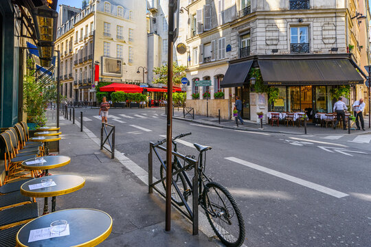 Cozy street with tables of cafe  in Paris, France