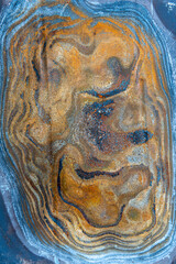 multi-colored discoloration on a piece of metal