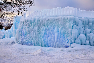 Blue wall of ice and snow in many shades of pastel colors on a winter day near Minneapolis Minnesota USA