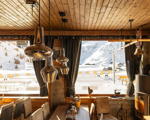 Mountain restaurant area, decorated in the national Austrian style, with panoramic windows to the mountains, 