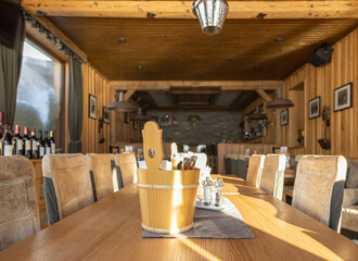 Hall of a sunlit Alpine restaurant with wooden and leather trim, Austria, Salzburg, Gastein Valley