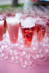 pink champagne in glasses with rough ice at a holiday wedding reception