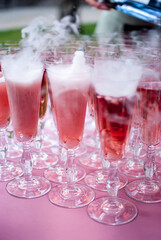 pink champagne in glasses with rough ice at a holiday wedding reception