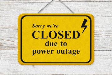 Closed due to power outage message yellow warning sign