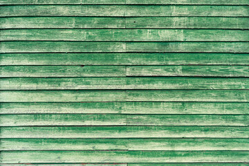 Wall made of old wooden boards with peeling paint