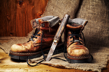 old leather boots on wooden table