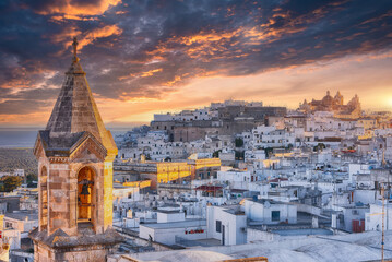Amazing view of old white town Ostuni and cathedral at sunset.