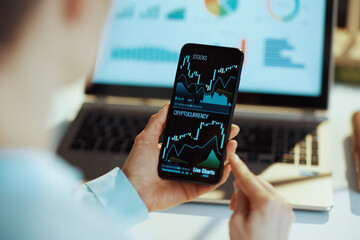 Modern woman exploring charts and investing in cryptocurrencies