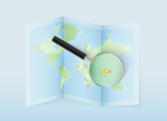 A folded world map with a magnifying lens pointing towards Bhutan. Map and flag of Italy in loupe.