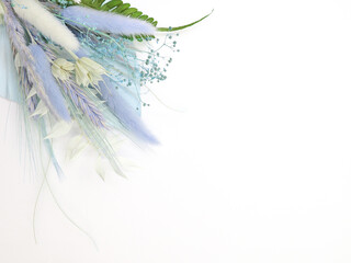 Spring card. Topper on the cake. Blue leaves of Palma and dry flowers. Flat lay. Top view. White background. High quality photo