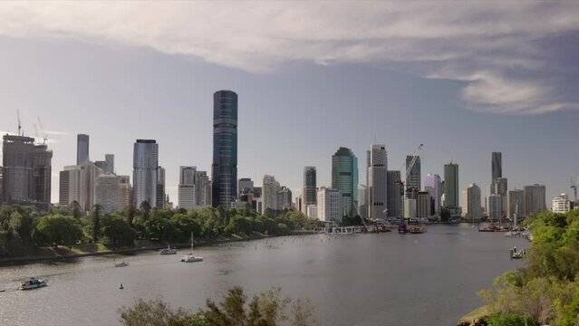 a summer afternoon zoom in shot of the city of brisbane and river from kangaroo point in queensland, australia