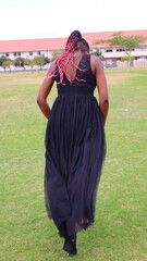 Naklejka premium black confident woman walking away 