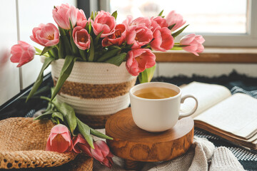 Cup of tea and basket with tulips, aesthetic still life