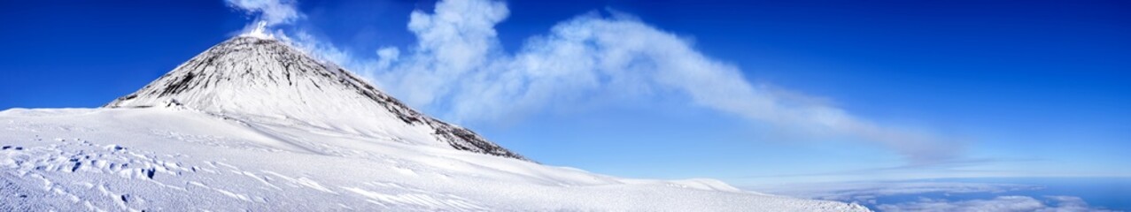 Smoking volcano in a snowy landscape