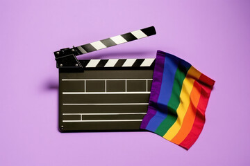 Rainbow flag and black clapperboard on purple background. LGBT CONCEPT. AI generated, human enhanced